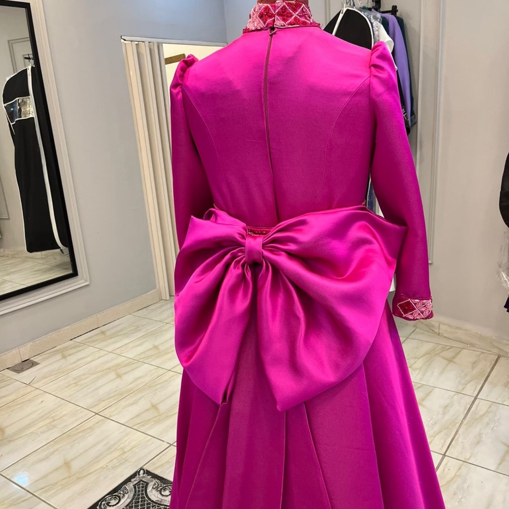 Couture evening gown with a detachable bow belt. Ankle length front view.